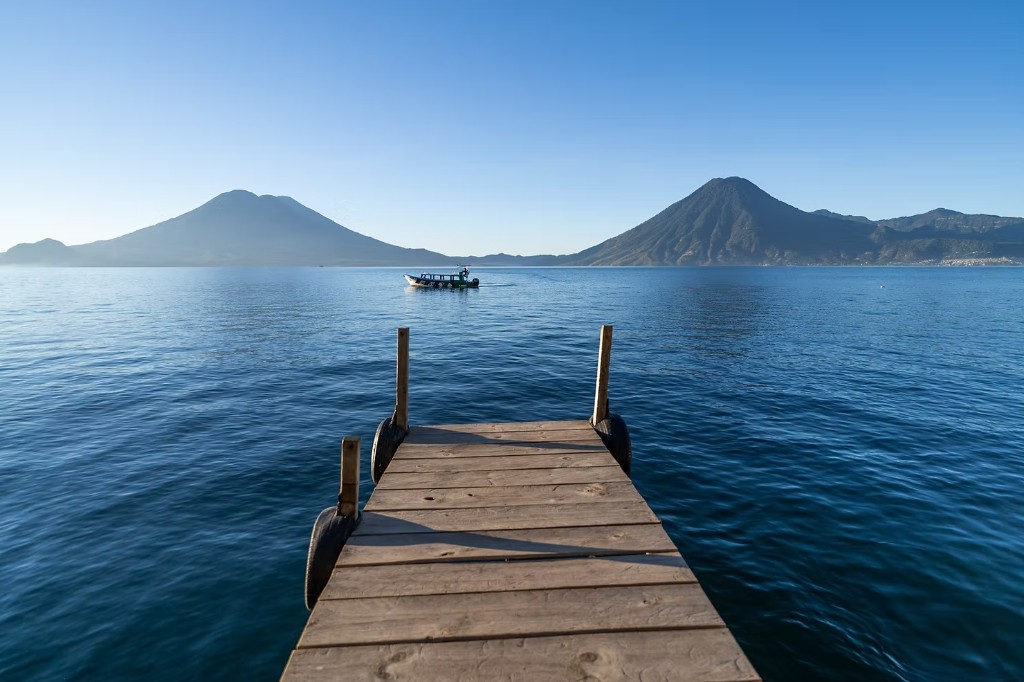 Dock on Lake Atitlán with volcanoes